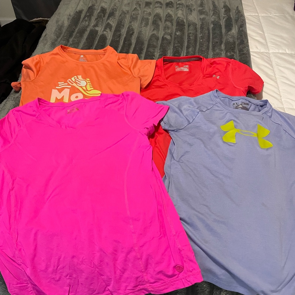 Four athletic tops and three shorts girls size S